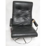 A 20th century black leather and chrome swivel armchair