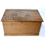 An early 20th century pine trunk with fitted candle box and drawer, H.45 W.84 D.51cm