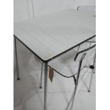 A vintage formica table and two chairs by Tavo