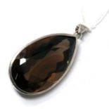 A large, sterling silver and faceted smokey-quartz tear-drop shaped pendant to a silver pendant