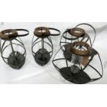 A set of four metal storm lanterns