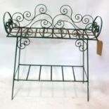 A green painted wrought iron planter