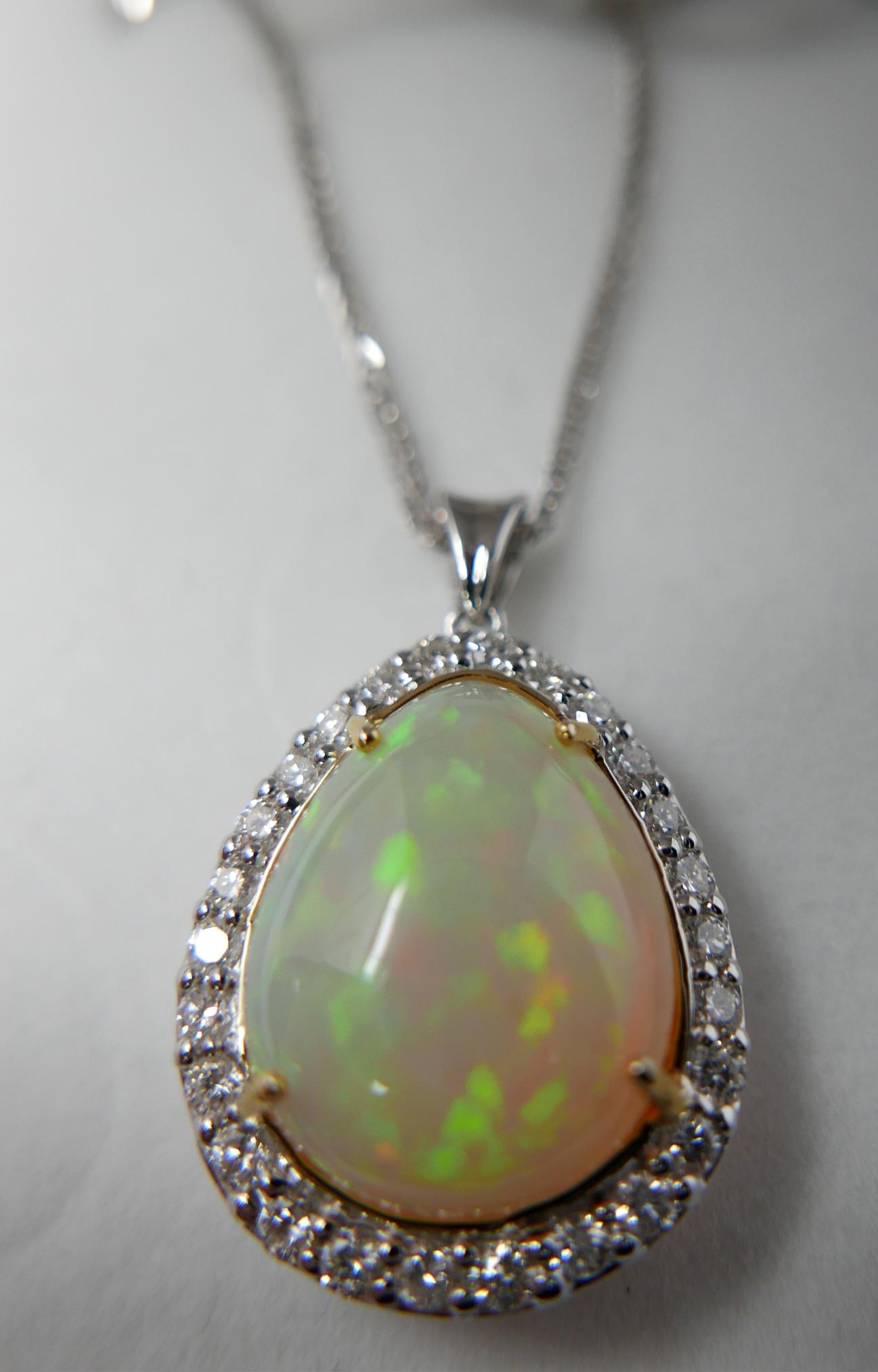 A boxed, 18ct white gold, diamond and pear-shaped opal pendant on an 18ct white gold chain, Pendant: