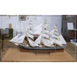 A good scratch built model of the Cutty Sark in perspex case standing on oak base. H.74 W.118 D.35cm