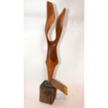 A modernist carved yew figure on wooden base. H.51cm