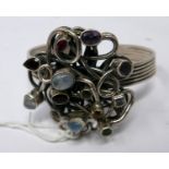 A sterling silver bangle set with a central silver cluster studded with moonstones, amethysts,