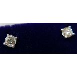 A boxed pair of 18ct white gold stud earrings (0.28 carats total), each earring set with a round,