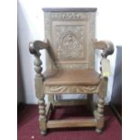 An 18th Century oak carved throne armchair, H.108cm