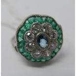 A platinum, diamond, emerald and aquamarine cluster ring, centrally set with an oval aquamarine