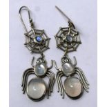 A pair of sterling silver and moonstone cabochon earrings composed of spiders suspended from webs,