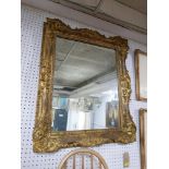 A 20th Century ornate gilt wood mirror. 100cm x 82cm