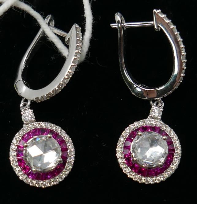 A boxed pair of 18ct white gold, ruby and diamond drop earrings, each earring set with a central