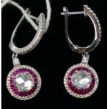 A boxed pair of 18ct white gold, ruby and diamond drop earrings, each earring set with a central