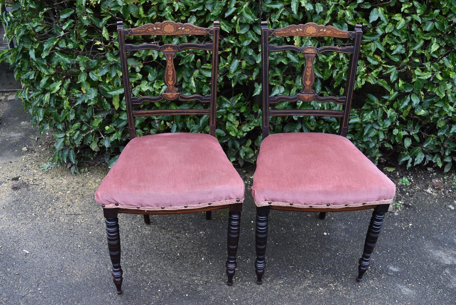 A pair Victorian bedroom chairs with profusely inlaid back rails and central splats on turned