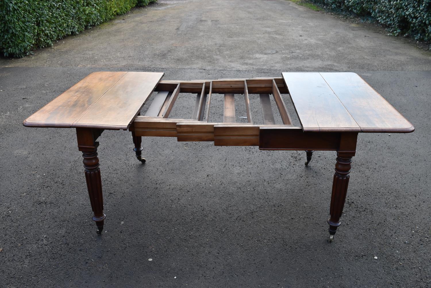 A George lV mahogany extending dining table on fluted supports, H = 74cm W = 113cm D = 59cm (lacks - Image 3 of 3