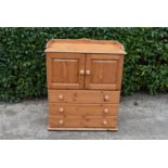 A pine cabinet with 3 drawers and pair of cupboard doors, H = 107cm W = 89cm D = 54cm