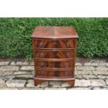 A petite Georgian style mahogany bow front chest of drawers raised on bracket feet, H = 60cm W =