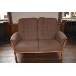 A 1970's Ercol style elm framed two seat sofa, H = 98cm W = 142cm D = 70cm