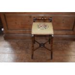 A late 19th century piano stool with needlepoint upholstered seat, H = 62 W =37cm D = 40cm