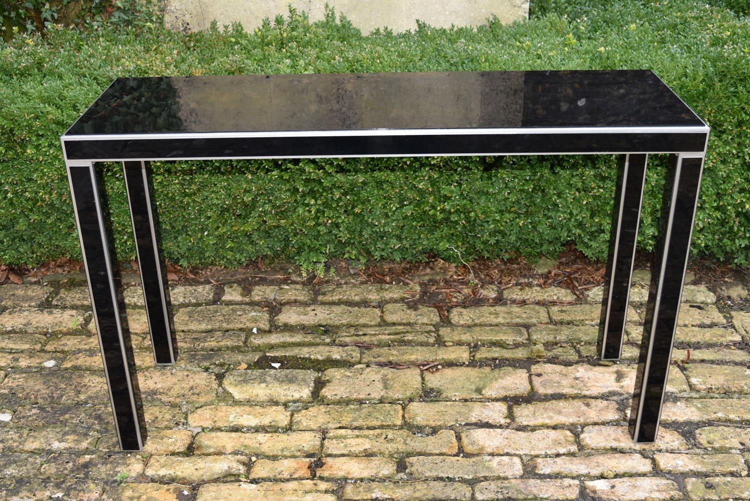 A black perspex console table, H = 77cm W = 122cm D = 39cm