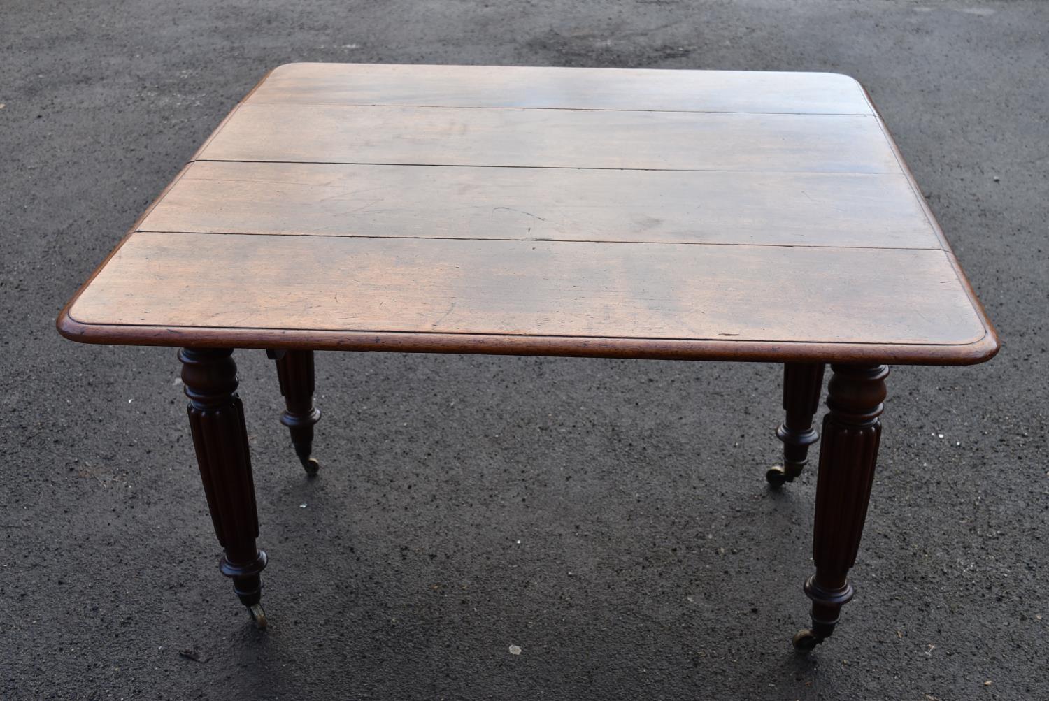 A George lV mahogany extending dining table on fluted supports, H = 74cm W = 113cm D = 59cm (lacks - Image 2 of 3