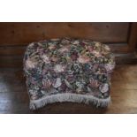 A floral upholstered footstool, H = 42cm W = 65cm D = 47cm
