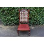 A late Victorian carved mahogany nursing chair, H = 105cm W = 51cm D = 45cm