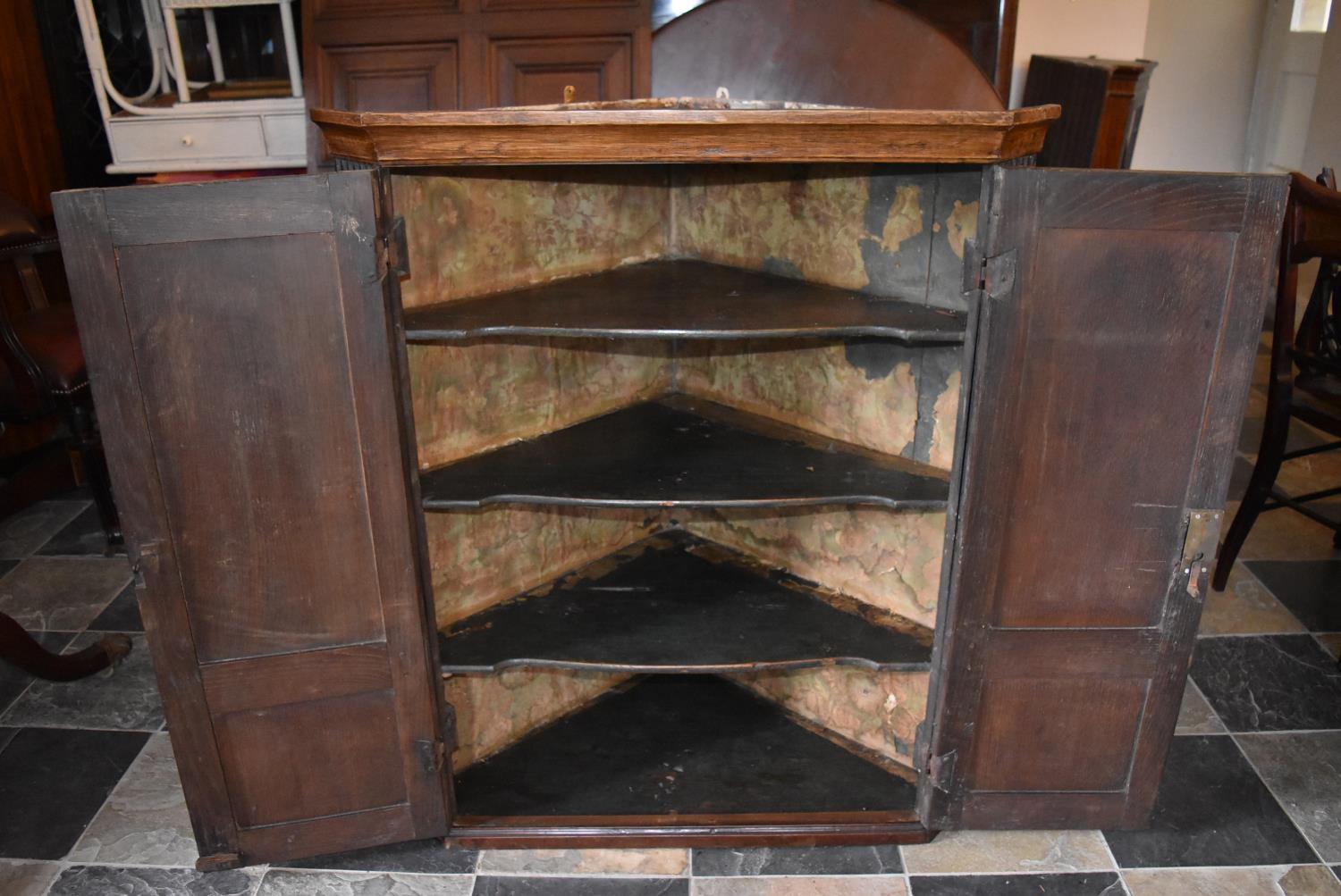 A Georgian oak hanging corner cupboard fitted panel doors and shelved interior. H = 104cm W = 89cm D - Image 2 of 2