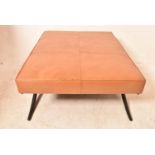 A large modernist leather stool in tan leather, H = 46cm W = 125cm D = 92cm (some scuffs to leather)