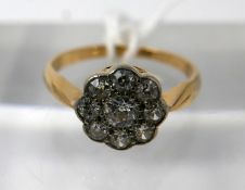 An 18ct yellow gold, diamond daisy ring, centrally set with nine, round, brilliant cut diamonds,