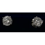 A boxed pair of 18ct white gold, diamond solitaire stud earrings (2.17 carats total), 4.8g