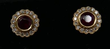A pair of 18ct yellow gold, ruby and diamond cluster stud earrings, 2g.