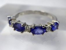 A 14 ct white gold, diamond and tanzanite ring, alternately set with three round briliant-cut