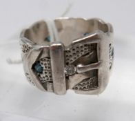 A Gentleman's sterling silver buckle-belt ring set with seven, round, faceted blue diamonds and