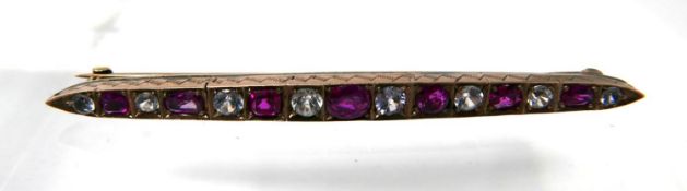 An 18ct and platinum, ruby and white sapphire bar brooch, 4 x 70mm, 7.3g.
