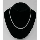 A boxed, 18ct white gold graduated diamond necklace of 18.05 carats set with a total of 125 round
