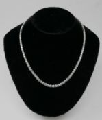 A boxed, 18ct white gold graduated diamond necklace of 18.05 carats set with a total of 125 round