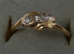 A boxed, 18ct yellow gold and diamond ring, centrally set with three round, brilliant cut