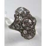 An 18ct white gold, Art Deco ring set with a large brilliant-cut diamond radiating to a further 8