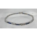 An 18ct white gold diamond and sapphire tennis bracelet, alternately set with thirty-two callibre-