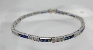 An 18ct white gold diamond and sapphire tennis bracelet, alternately set with thirty-two callibre-