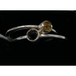 Two boxed, sterling silver rings set with one faceted yellow and one black diamond, Sizes: P & Q 1/