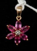 A 9ct yellow gold pendant composed of a flower-head set with 6 pink tourmaline petals and diamond