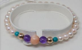 A cased and boxed, 9ct yellow gold, pearl, turquoise, amethyst and coral bracelet, Dia: 8cm, 8.5g