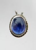 A single natural sapphire cabochon set into an antique silver mount, Cabochon: 5 x 4mm, 0.4g