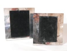 A pair of boxed, silver-plated photograph frames, 22 x 23cm and 20 x 21cm.