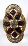 An 18ct yellow gold, ruby and diamond ring, set with a central round, brilliant-cut diamond to