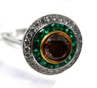 An Art Deco style, 18ct white gold emerald and diamond target style ring, centrally set with a