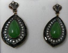 A boxed pair of drop earrings set with a pear-drop, translucent green jade cabochon surrounded by