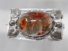 An Arts and Crafts, sterling silver rectangular brooch centrally set with an oval, agate cabochon